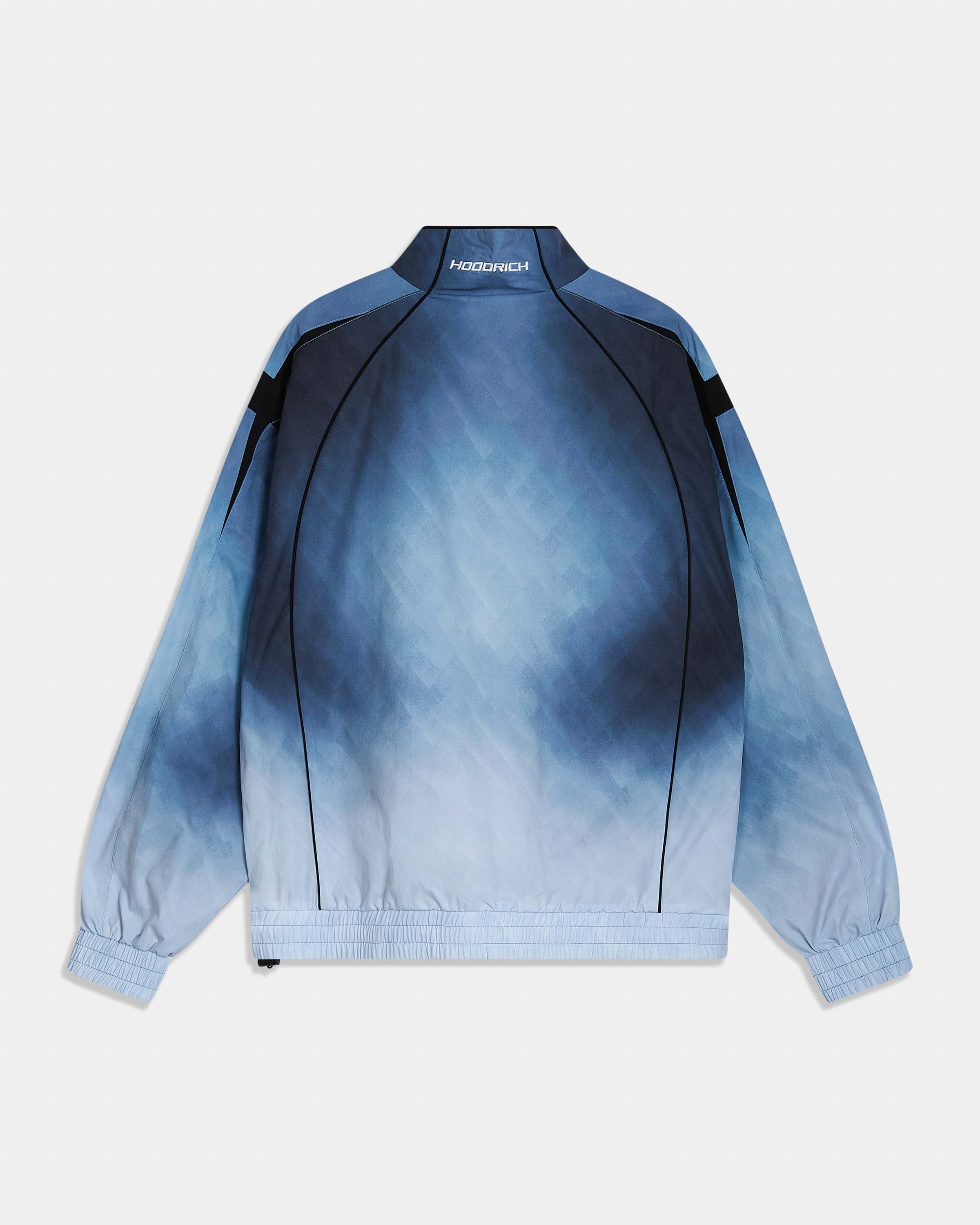 A long-sleeve bomber jacket with Hoodrich on the neckline, shown from the back. The jacket features a blue and white tie-dye gradient pattern with solid dark blue panels on the shoulders and upper back, black piping details, and elastic cuffs and hem.