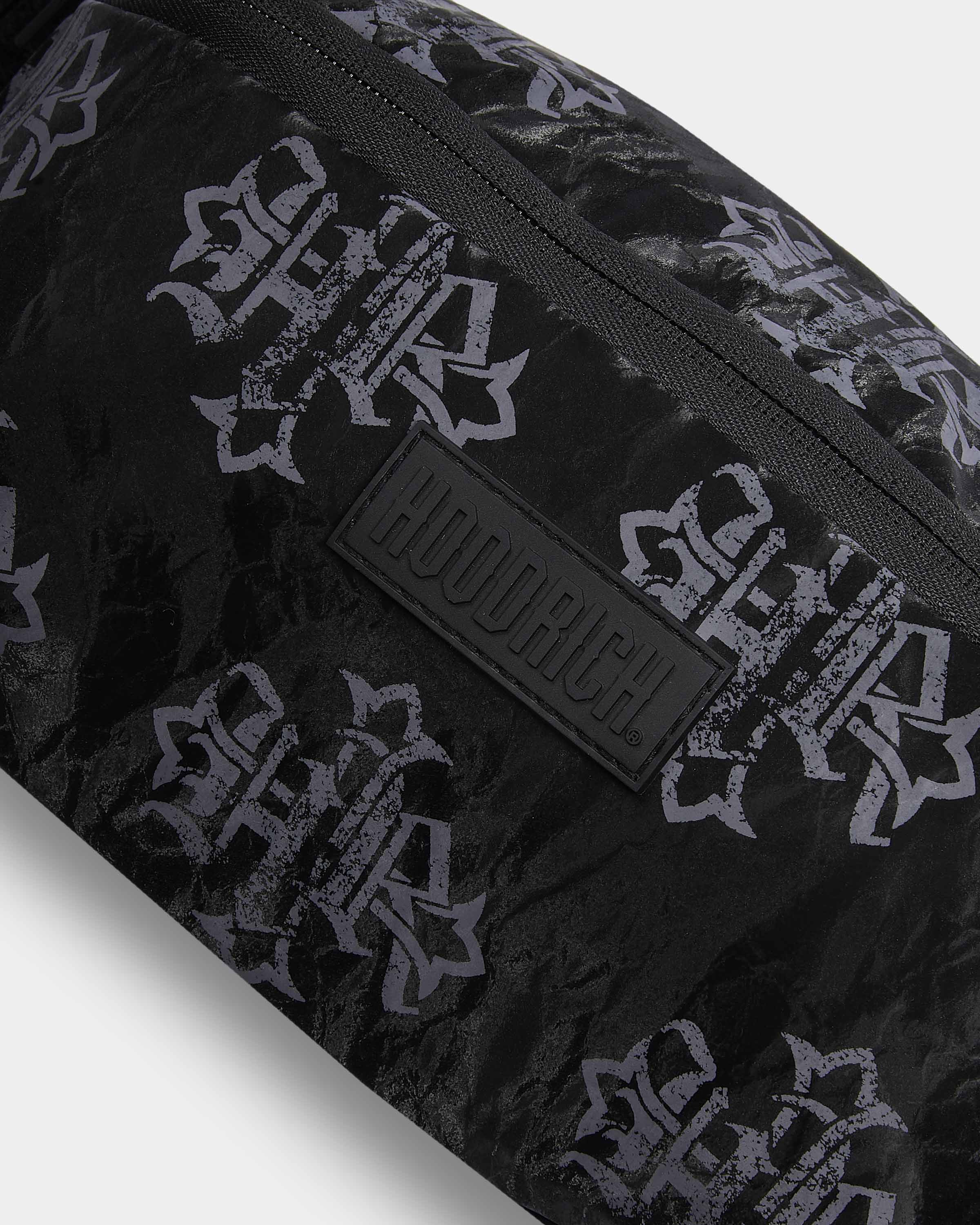 Black bag with white pattern and visible brand logo on a light gray background