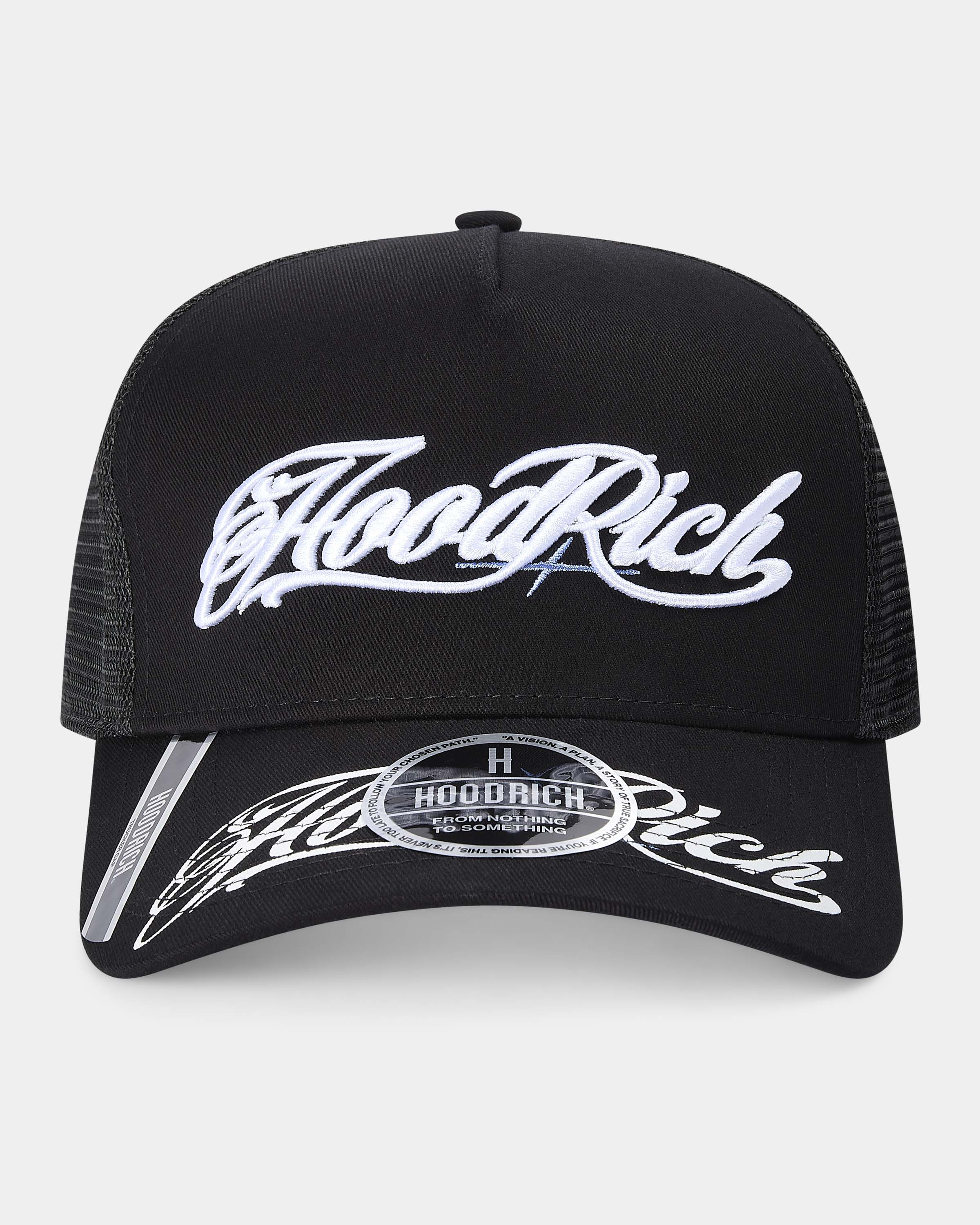 Black trucker cap with white "Hoodrich" embroidered on a light gray background