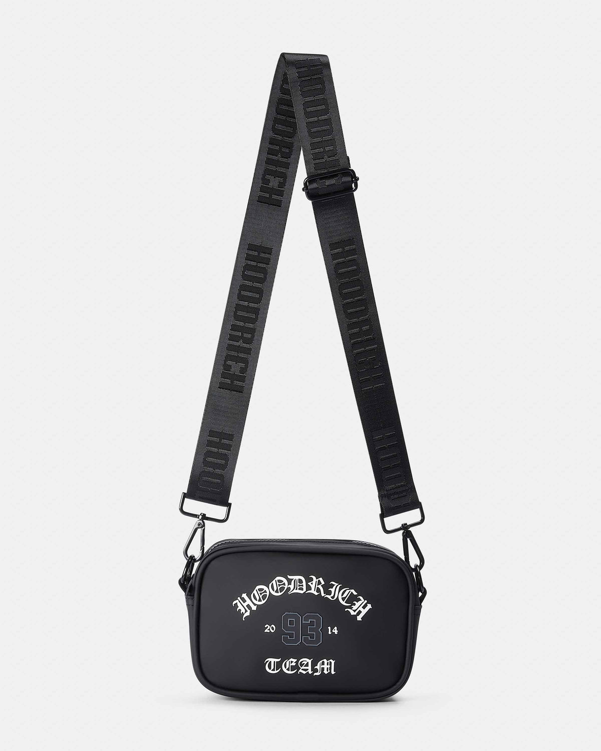 A black rectangular crossbody bag with a wide, adjustable black strap featuring white lettering. The front of the bag is black with white text reading 'HOODRICH TEAM'.
