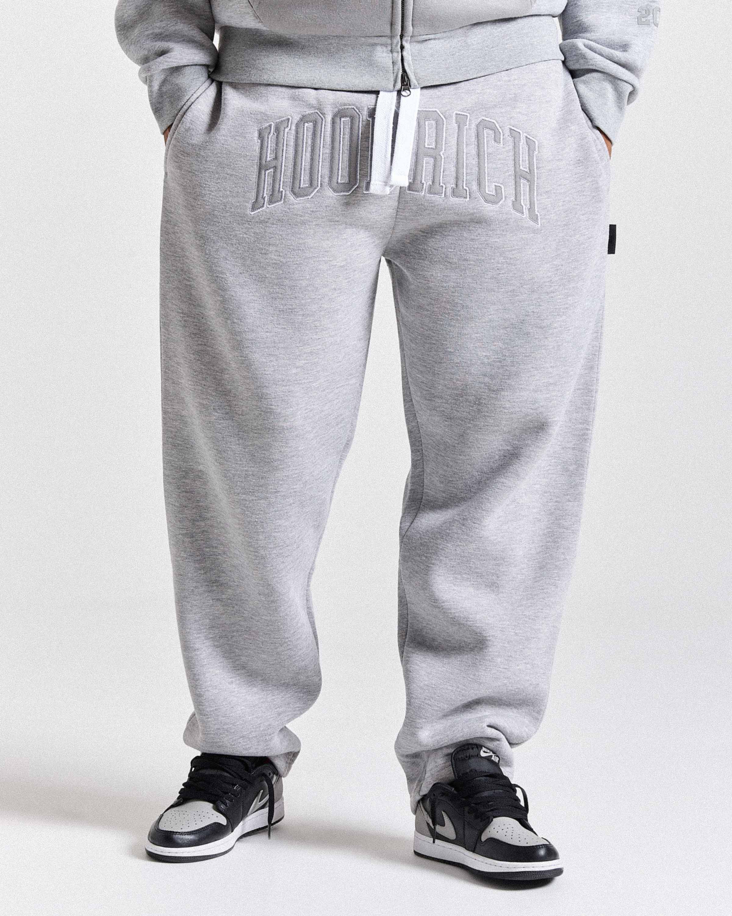 Gray sweatpants with 'HOODRICH' branding on a white background
