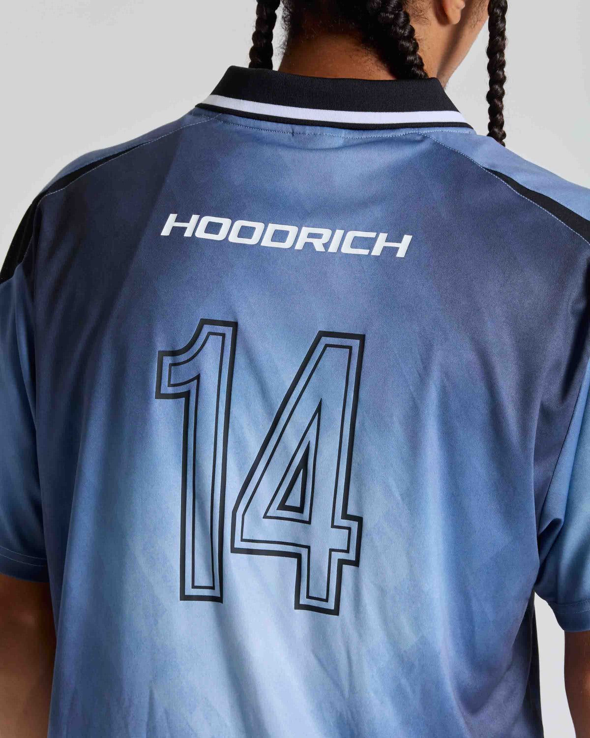 Back view of a blue HOODRICH soccer jersey with the number 14 and white brand logo, worn by a model.