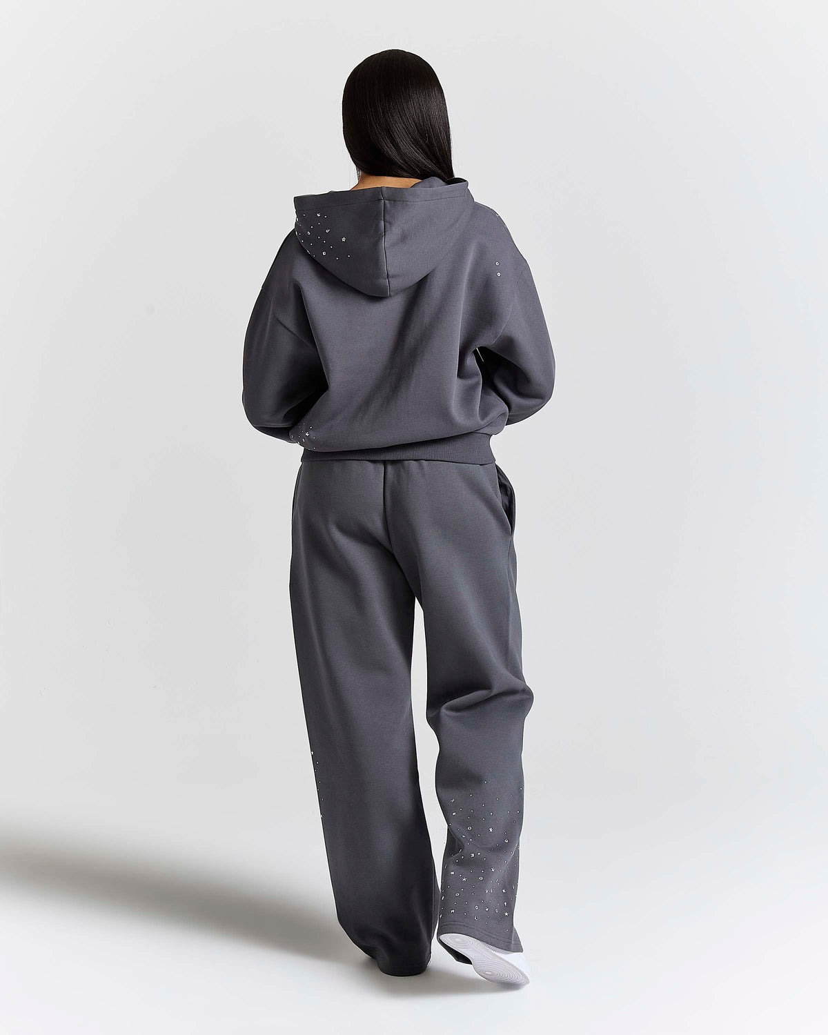 Displays a model wearing the grey 'Hoodrich' branded women's Clash Full Tracksuit 
