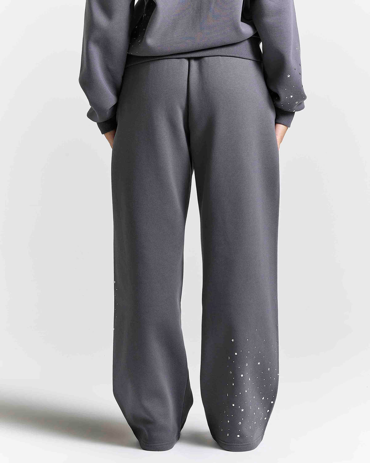 Displays a model wearing the grey 'Hoodrich' branded women's Clash Full Tracksuit 
