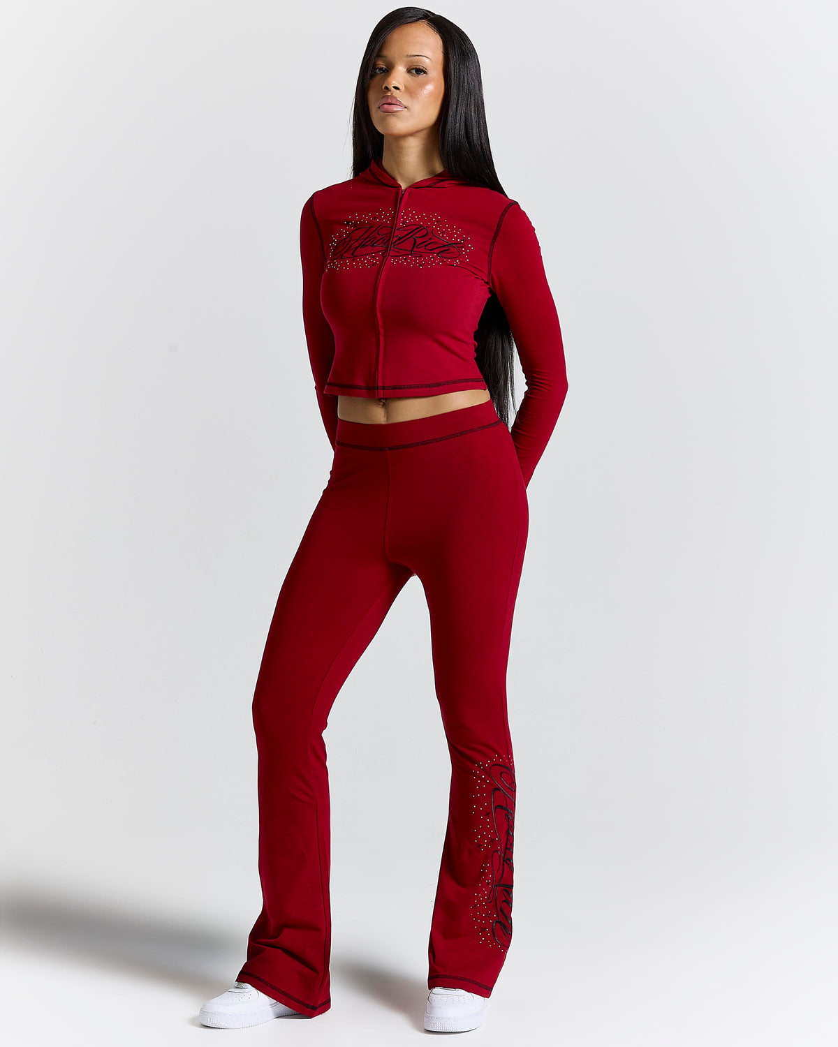 Displays a model wearing the red 'hoodrich' branded Gleam V2 Fitted Z/T Hoodie 