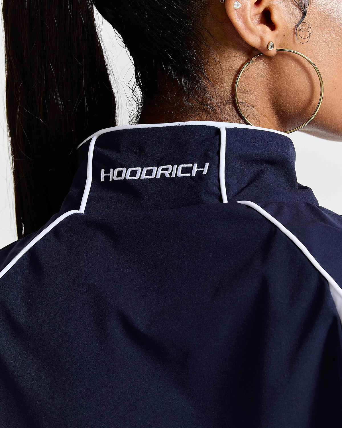 Navy blue jacket with 'HOODRICH' branding on a plain background