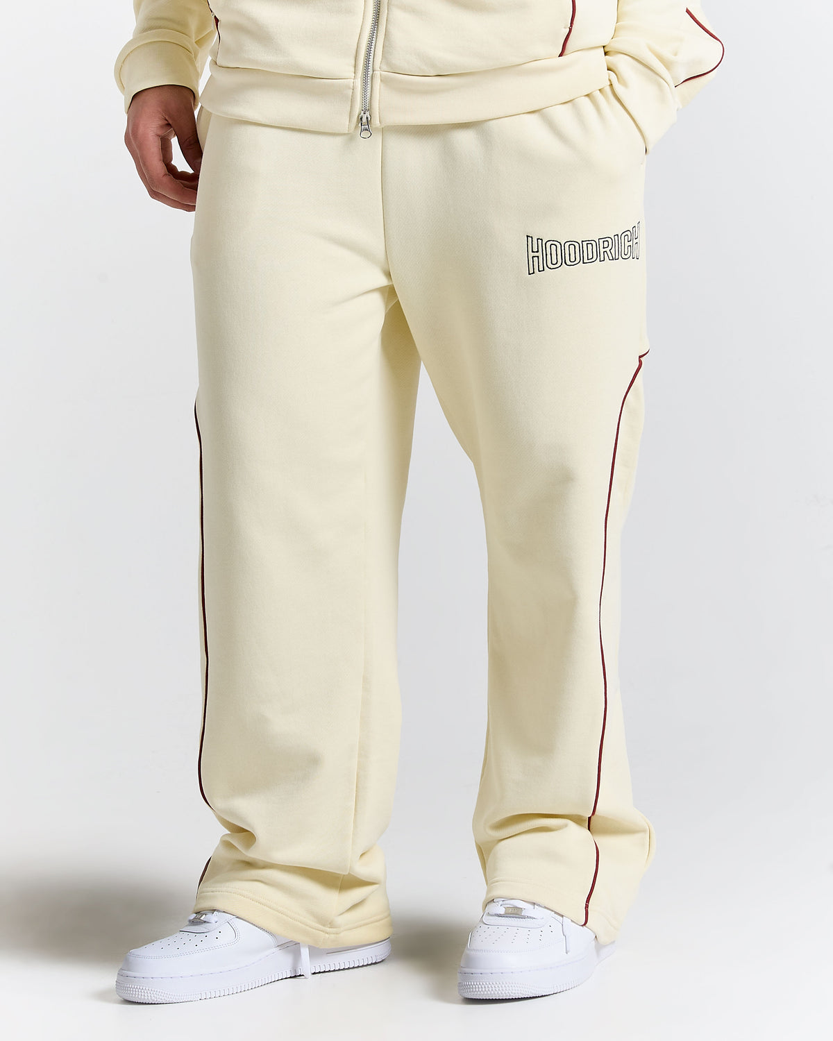 Beige sweatpants with a brand logo on a white background
