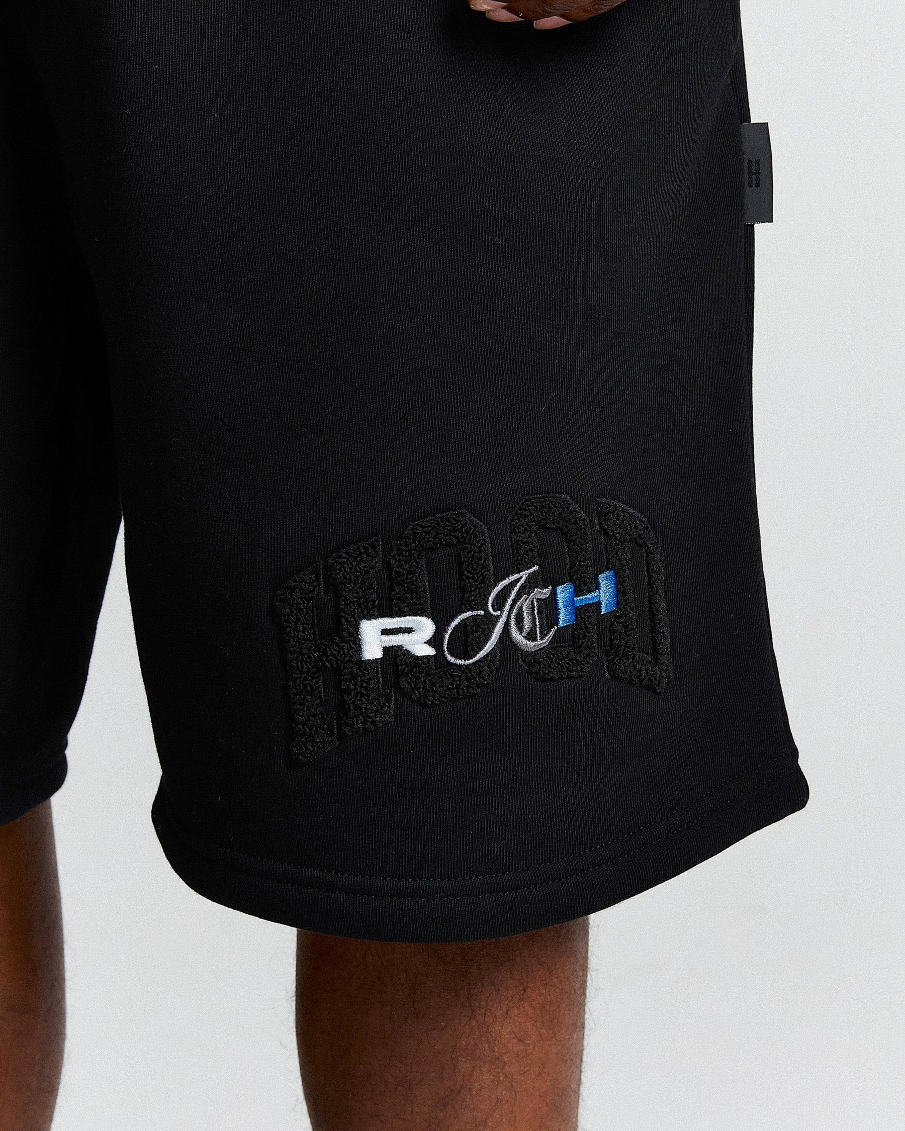 Black shorts with a logo on a white background