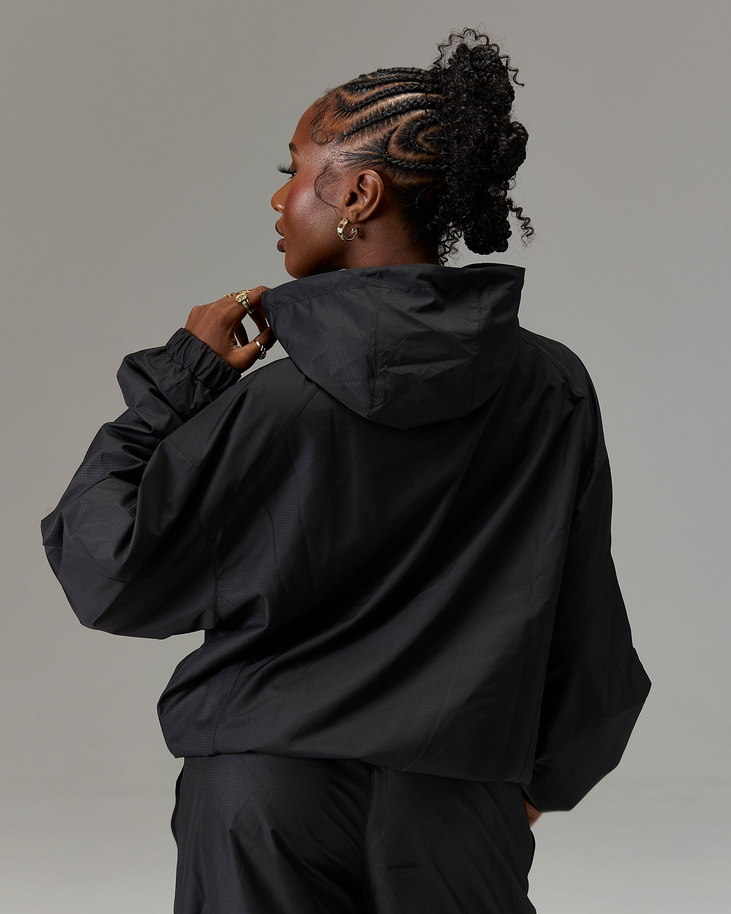 Displays a model wearing the Black 'Hoodrich' branded women's The Winner's Circle Ripstop Woven Full Tracksuit