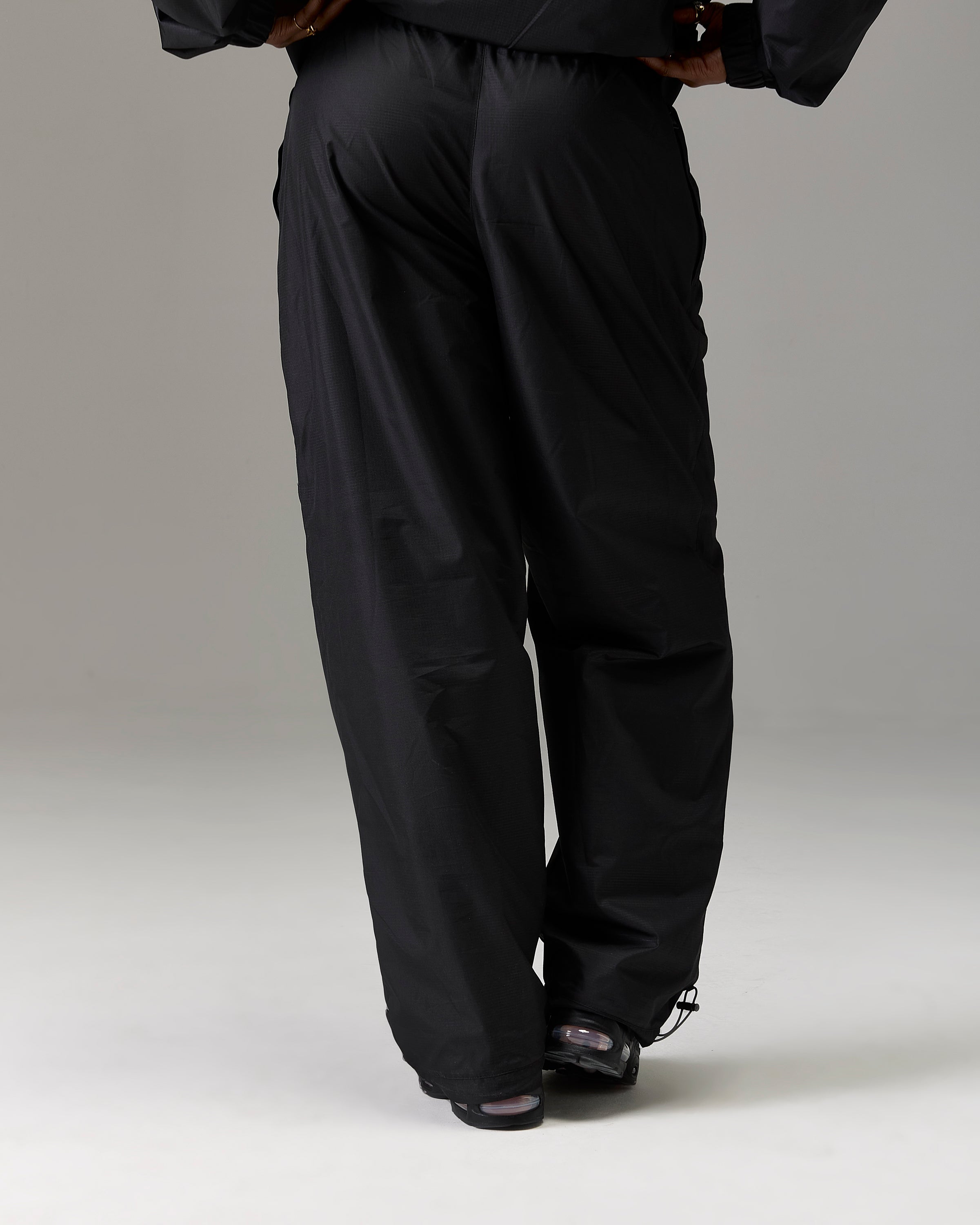 Displays a model wearing the Black 'Hoodrich' branded women's The Winner's Circle Ripstop Woven Full Tracksuit