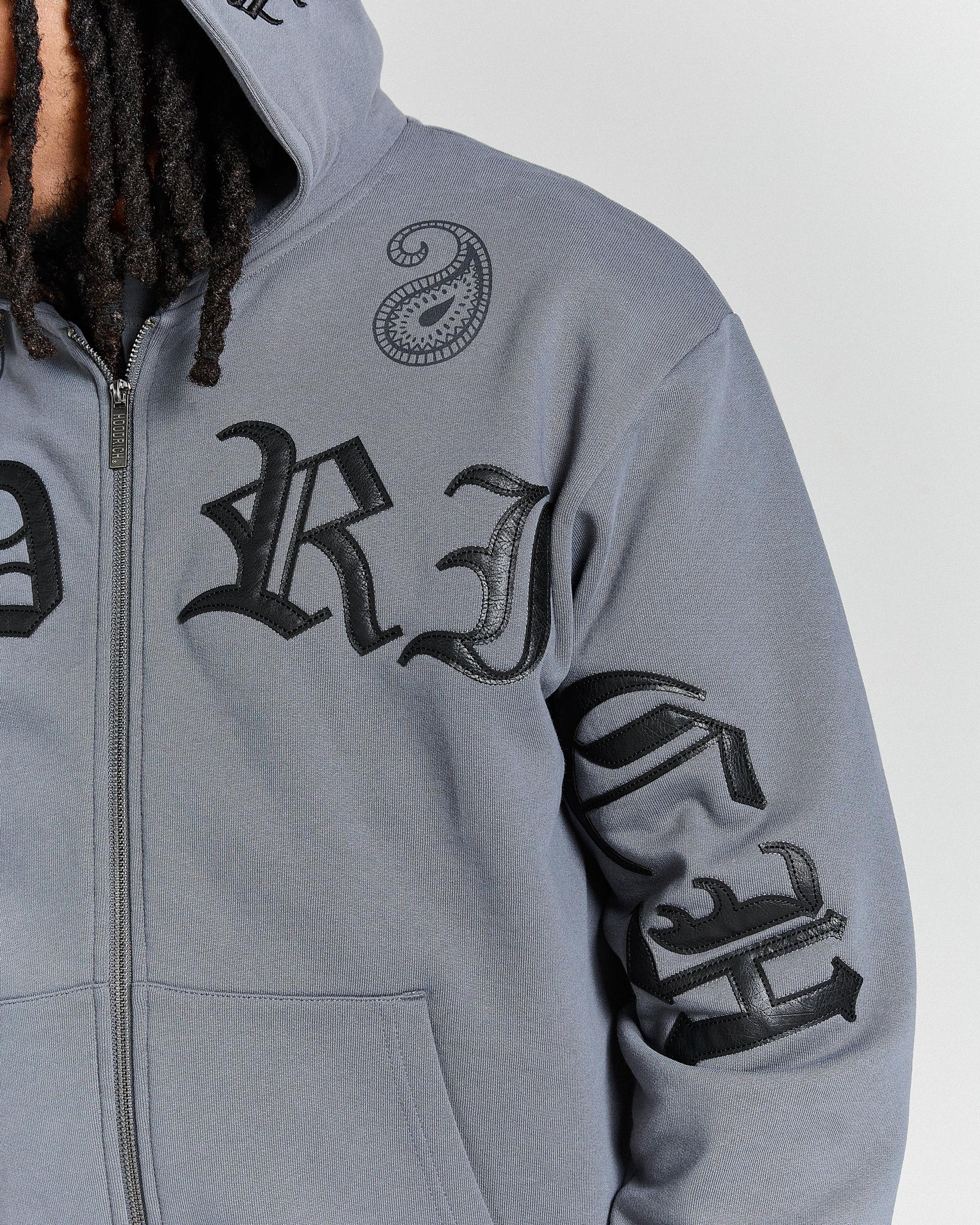 Gray hoodie with black lettering and designs on a plain background