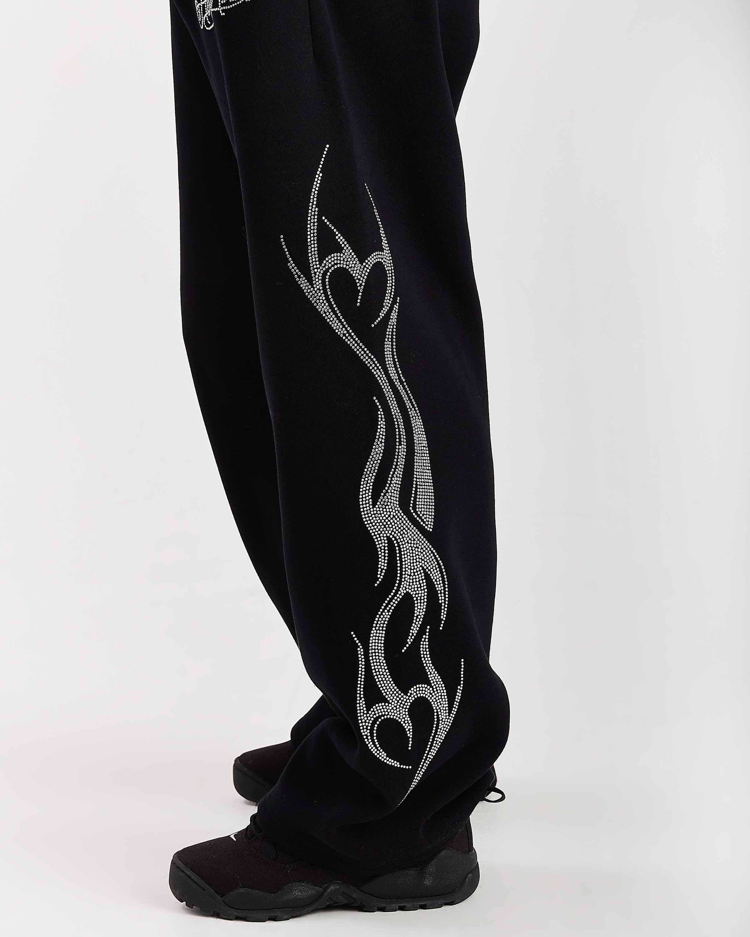 Black pants with silver tribal design on a white background