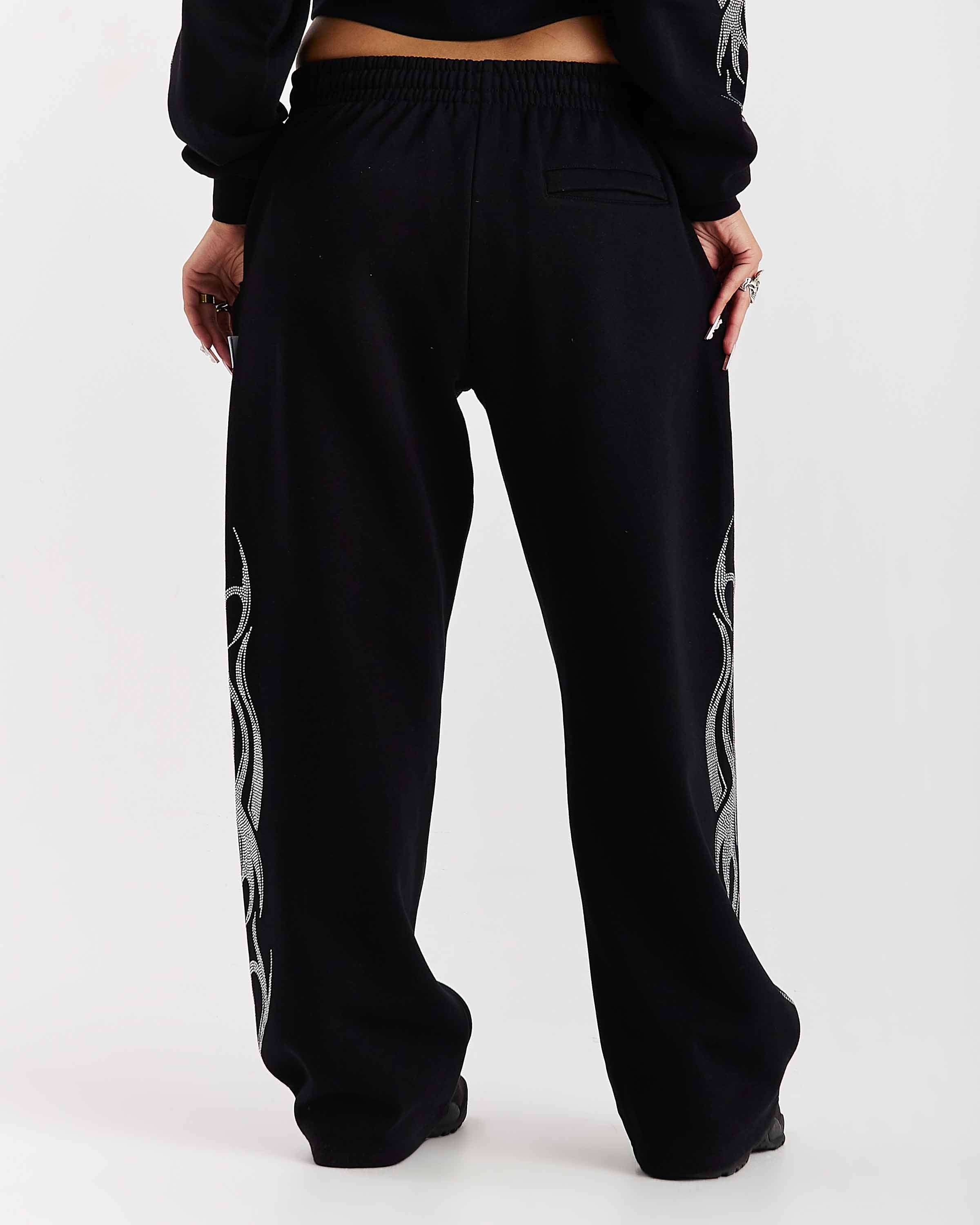 Black jogger pants with white patterns on a white background
