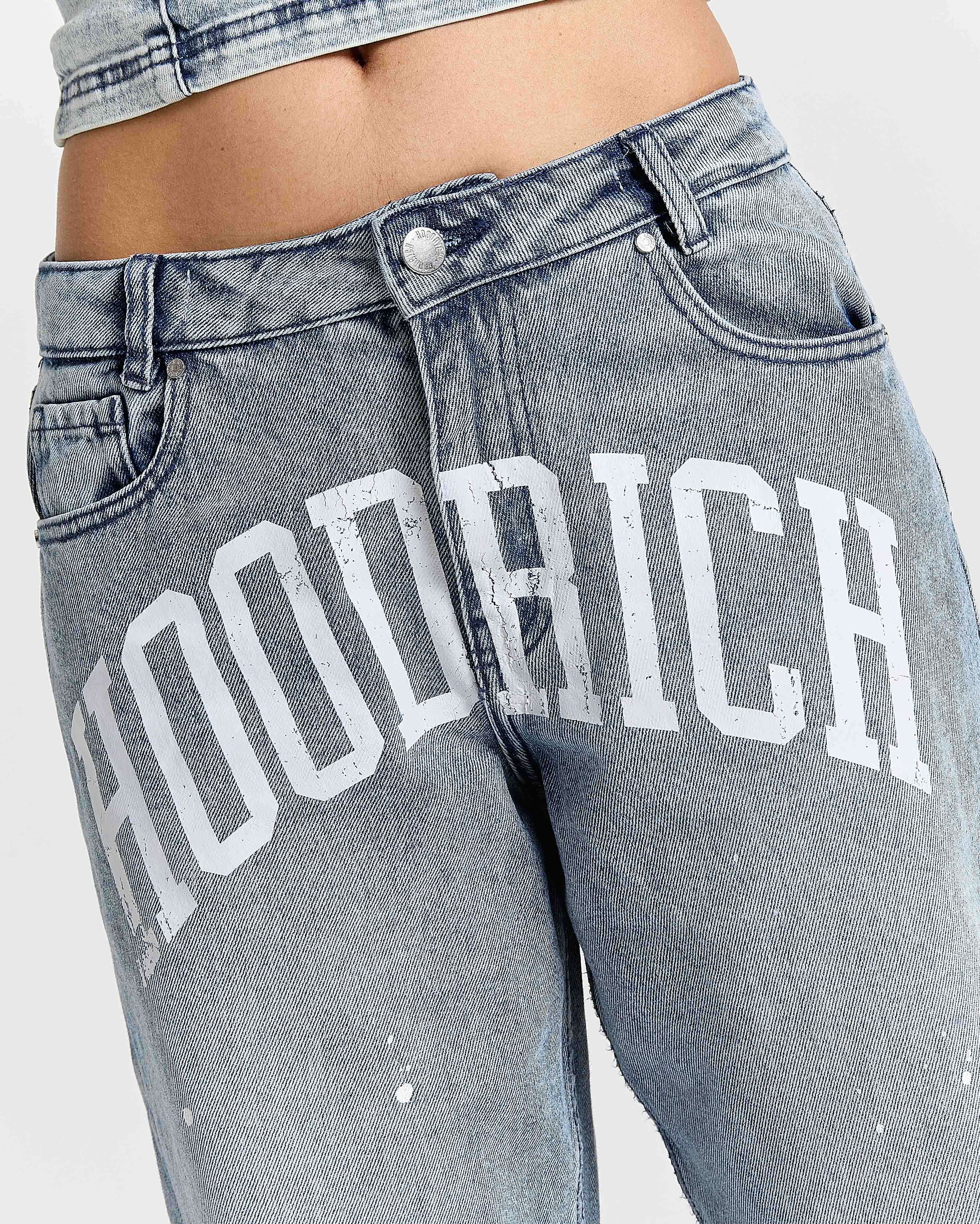 Gray jeans with 'Hoodrich' branding on a white background